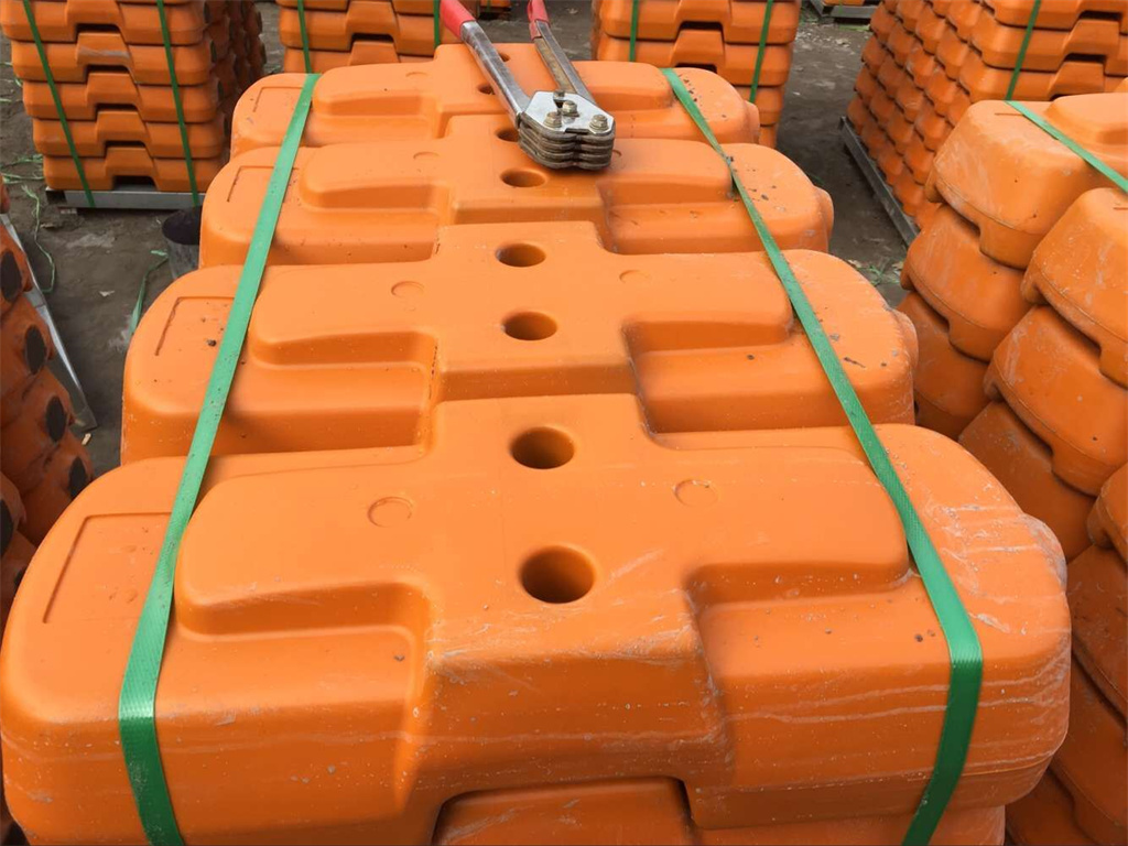 Temporary fence feet packed with plastic belt in pallet