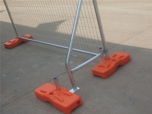 Orange temporary fence base installed with bracing in our factory