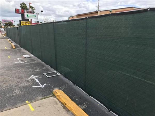 The shade cloth installed with chain link fence in front of house