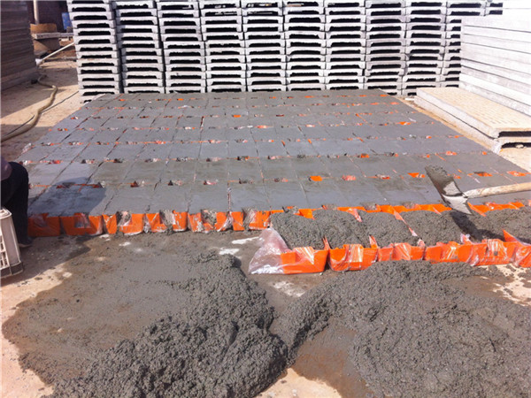 Injection molding temporary fence feet filled with concrete