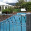 galvanized rroll top pool fencing around a pool