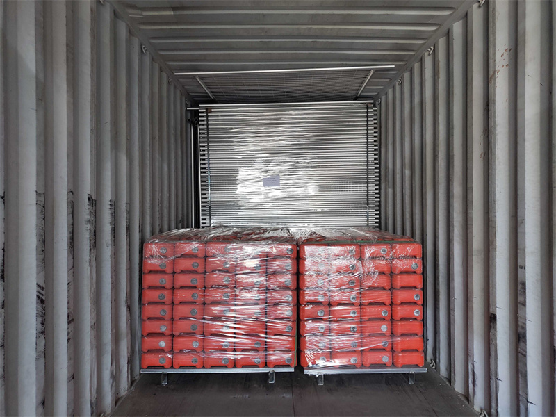 The temporary fence panels and plastic feet are loaded into container