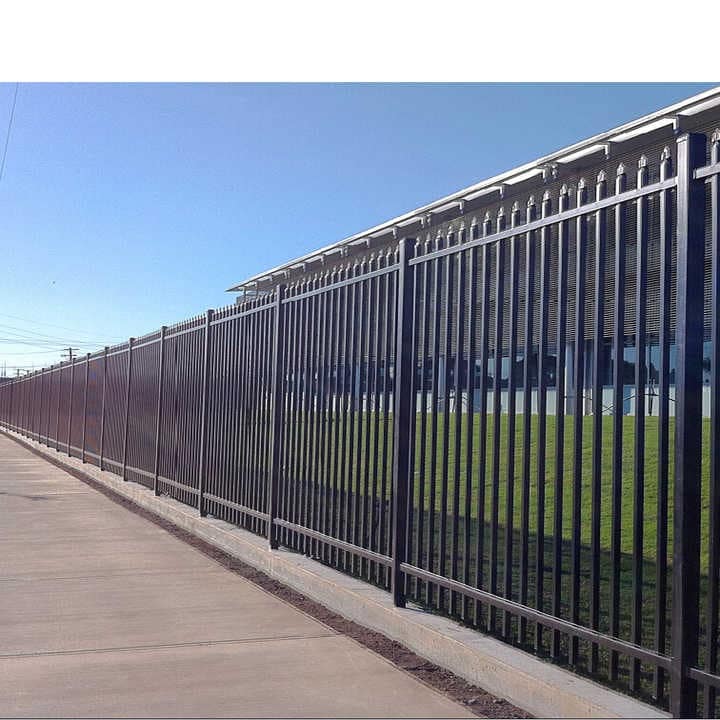 Elegant steel picket fence surrounding a residential property, showcasing its decorative and security features.