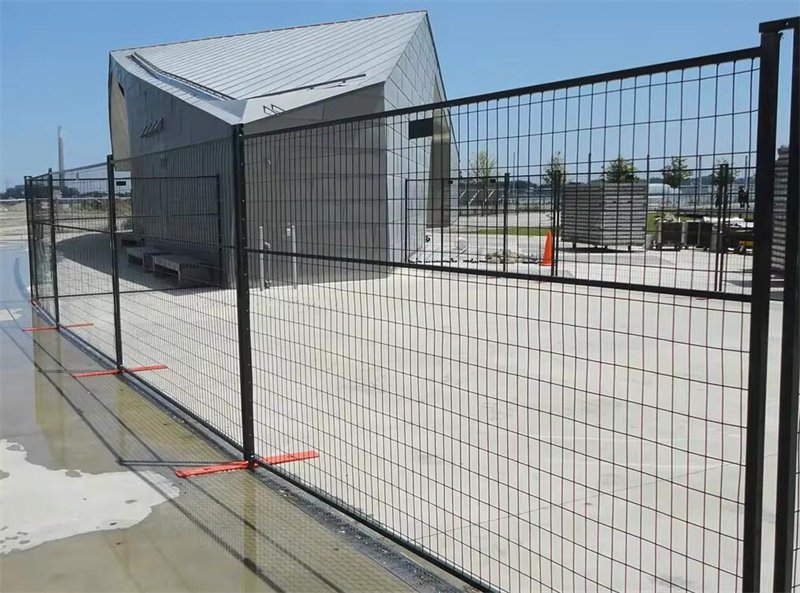 erial view of a large construction site in Canada enclosed by high-quality temporary construction fencing to ensure safety and security.