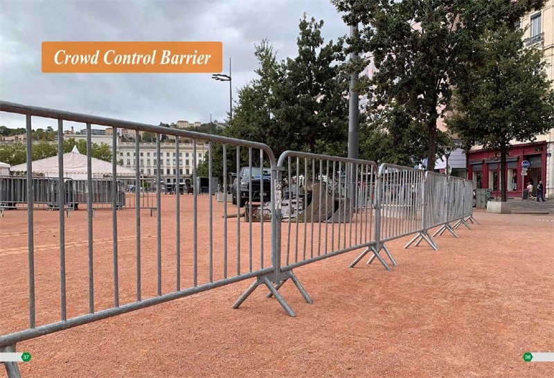 Steel crowd control barrier with interlocking hook system, seamlessly connected in a linear arrangement at an outdoor concert venue.