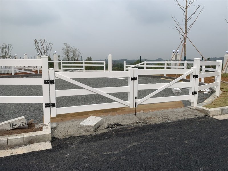 Affordable PVC horse arena fencing with a double gate, showcasing durable and cost-effective equestrian enclosure solutions.