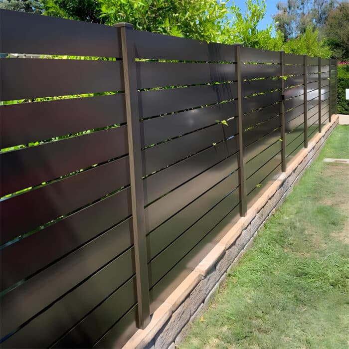 Modern brown aluminium slat fence providing a sleek privacy solution, with horizontal slats and a sturdy frame.