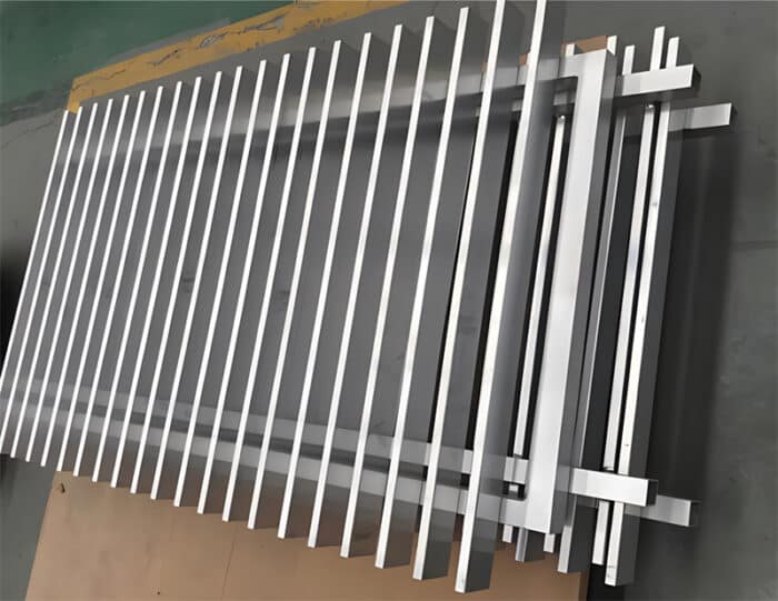 Close-up view of aluminium blade fence panels in silver, showcasing the sleek and durable design of the vertical slats.