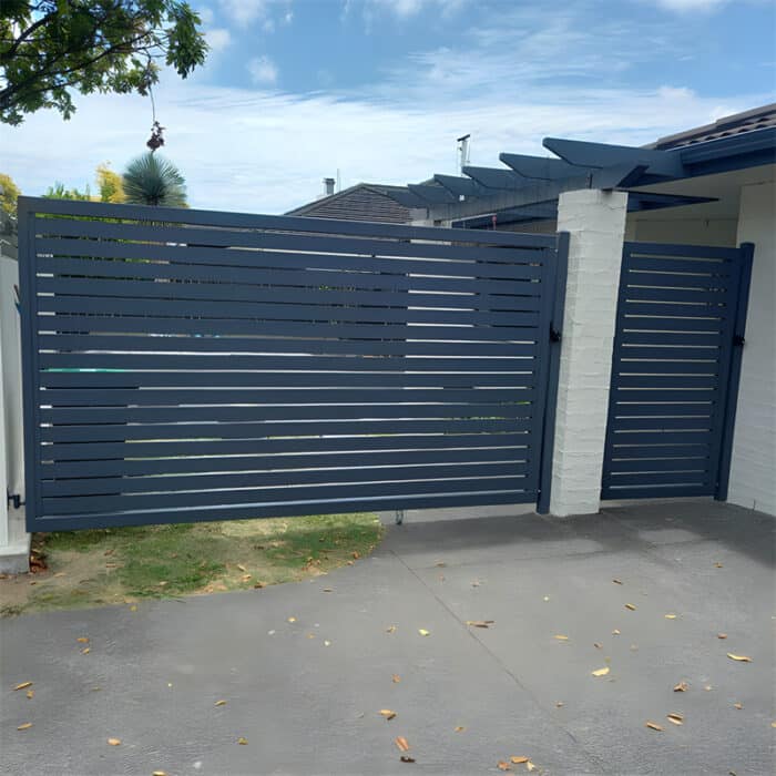 Contemporary dark blue aluminium gates with horizontal slats, installed in a residential driveway for secure and stylish access.