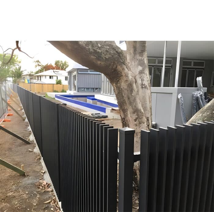 Black aluminium blade fence installed around a residential property, providing a secure and stylish barrier with vertical slats.