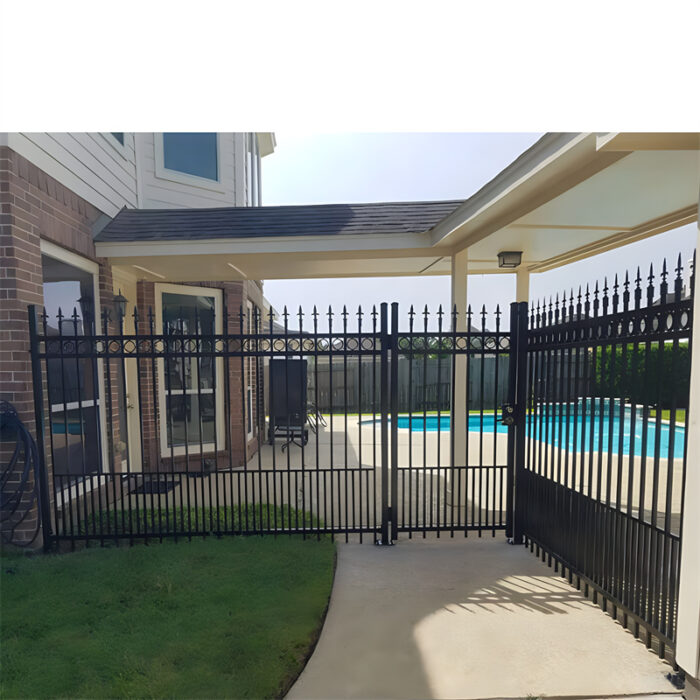 Black aluminum spear top fencing installed around a pool area in a residential backyard.