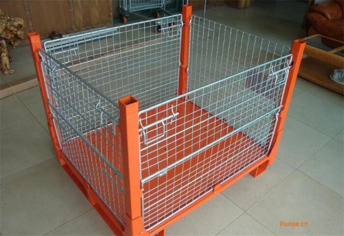 Orange and galvanized steel stillage cage with mesh sides, displayed in an indoor setting.