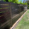 Modern brown aluminium slat fence providing a sleek privacy solution, with horizontal slats and a sturdy frame.