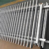 Close-up view of aluminium blade fence panels in silver, showcasing the sleek and durable design of the vertical slats.