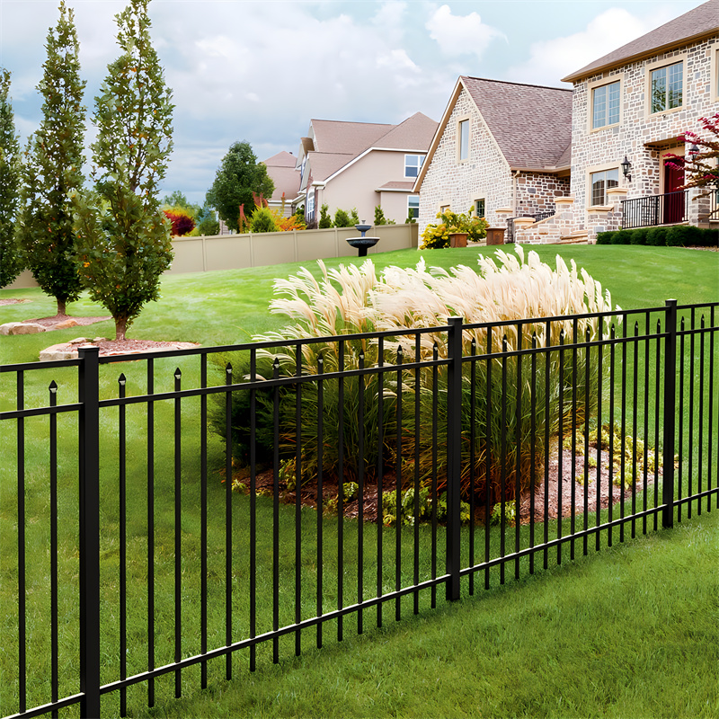 A beautifully landscaped residential property with black aluminum spear top fencing.