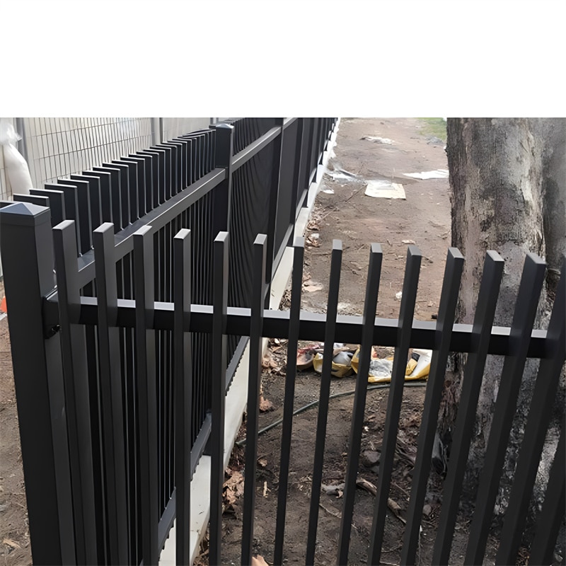 Black aluminium blade fence installed along a garden path, demonstrating the modern and secure design of the fencing.