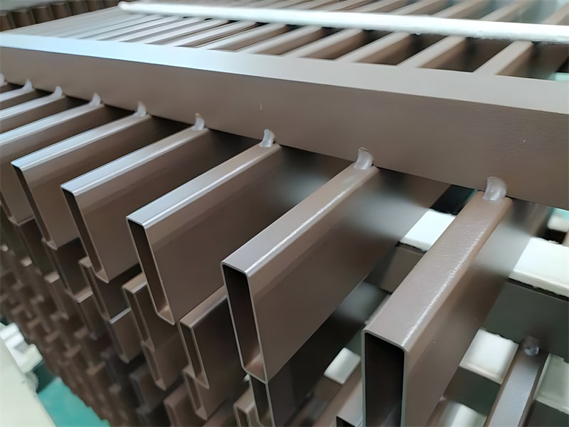 Close-up view of a brown aluminium blade fence showcasing the vertical slats and sturdy construction, highlighting the durability and quality of the material.