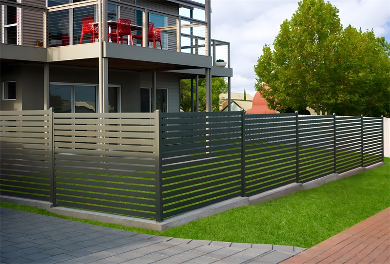 Modern grey aluminium slat fence installed around a residential property, providing stylish privacy and security with horizontal slats and a sleek design.