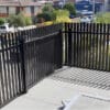 Close-up view of brown aluminium blade fence showcasing the vertical slats and robust construction, emphasizing durability and quality.