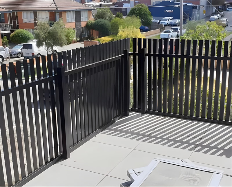 Close-up view of brown aluminium blade fence showcasing the vertical slats and robust construction, emphasizing durability and quality.