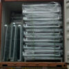 Container filled with neatly stacked and wrapped collapsible stillage cages ready for shipment.