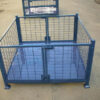 Blue steel stillage cage with double swing doors, placed in an outdoor storage area.