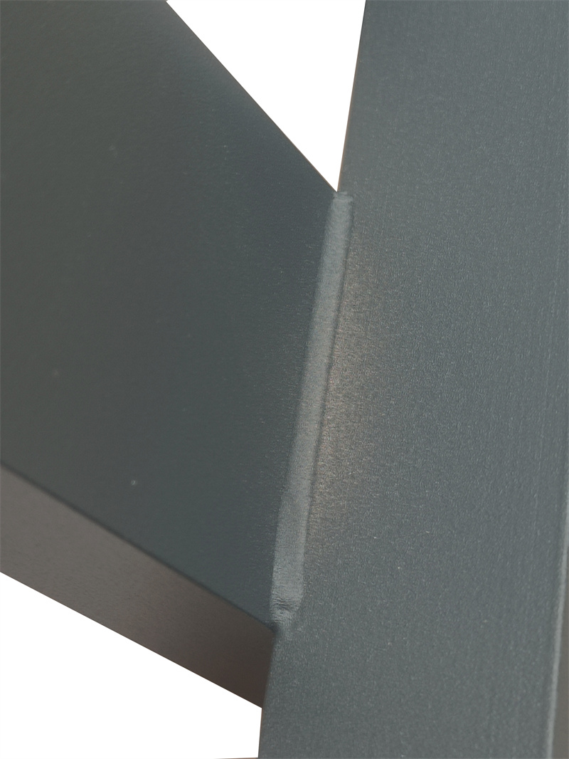 Detailed close-up of a smooth welded joint on a matte black aluminium blade fence, highlighting the precision of the construction.