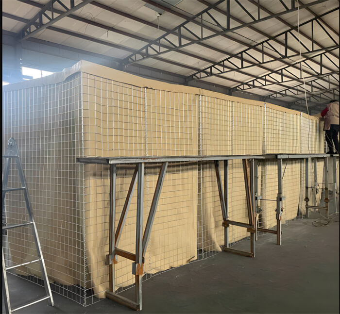 Industrial assembly of large Hesco Bastion barriers at a China factory, showcasing high-strength galvanized wire mesh and durable fabric for enhanced security and protection.