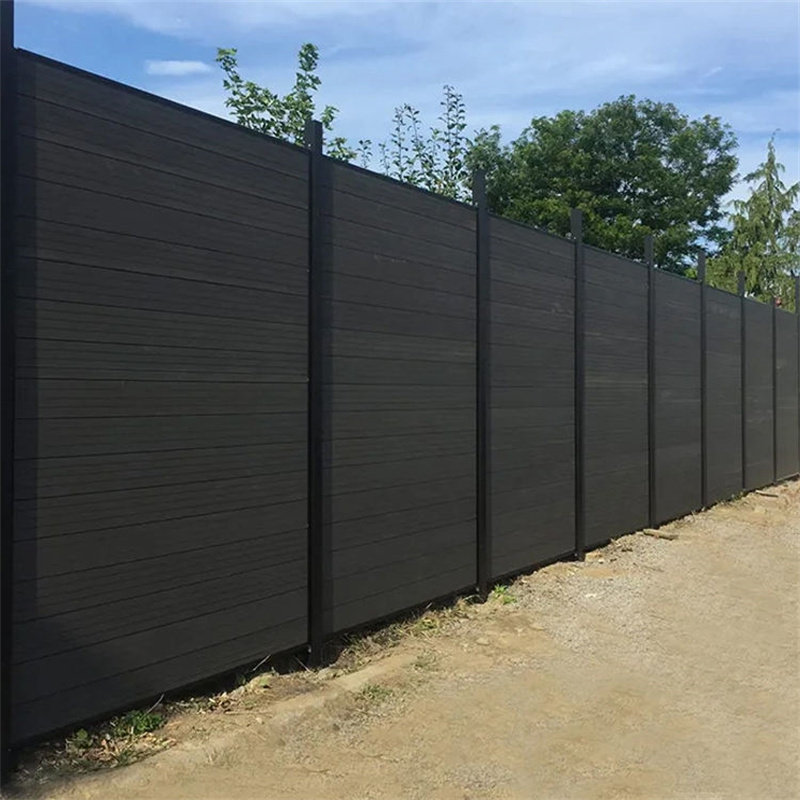 Tall black aluminum privacy fence installed along a property boundary, providing a sleek and modern solution for security and seclusion.