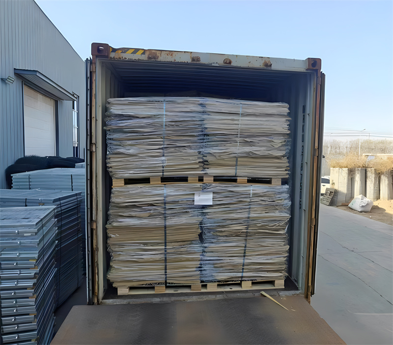 Shipping container filled with securely packed hesco barriers, prepared for delivery.