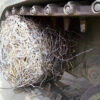 Close-up of a tank track entangled in wire mesh, effectively immobilizing the vehicle by wrapping the tracks, demonstrating the effectiveness of the tank track mesh as an anti-tank barrier.