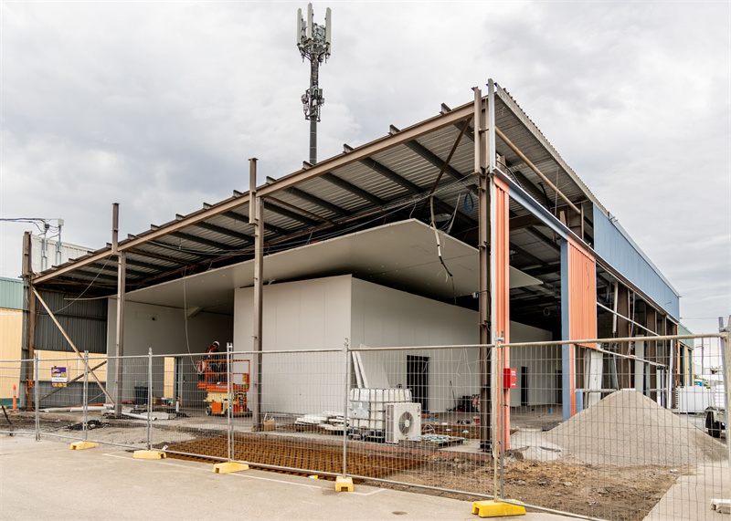 Construction site surrounded by temporary fencing, providing safety and security.