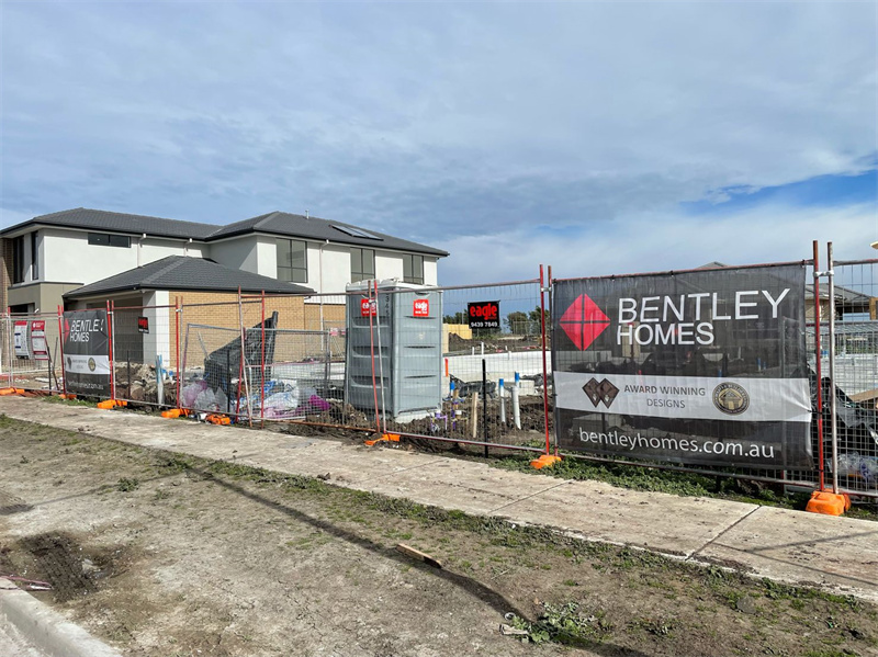 Fencing around a construction site, featuring banners and providing protection for ongoing work.