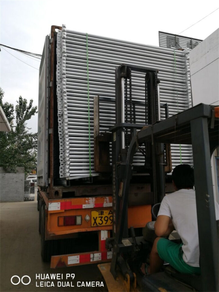 High-quality galvanized cattle panels being loaded onto a truck for delivery.