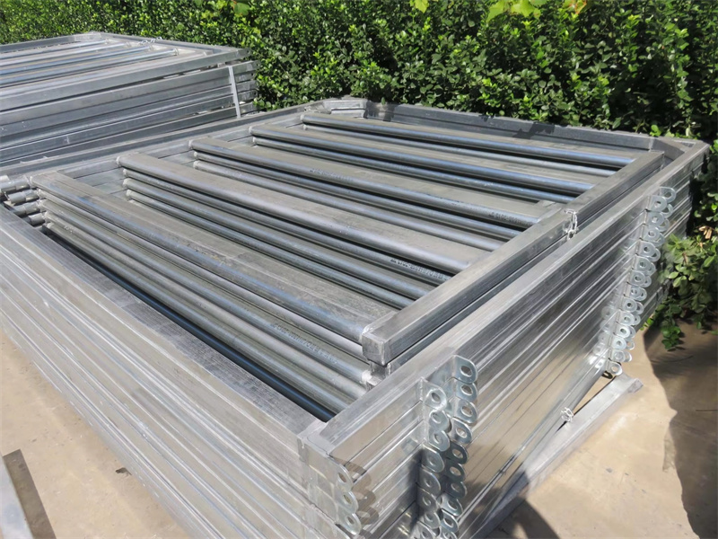 A stack of 1.8m x 2.1m heavy-duty galvanised cattle yard panels, neatly packed for shipment, demonstrating efficient storage and transport solutions.