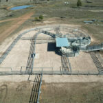 Aerial view of a large cattle pen setup, demonstrating the extensive use of steel bull panels for efficient farm operations.