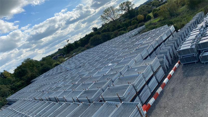 Aerial view of stacked temporary fencing panels, ready for deployment for various events or construction sites.