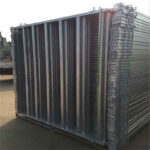 Neatly stacked galvanized horse fence panels packed on steel pallets, ready for transport or storage, highlighting efficient bulk packaging.