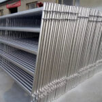 Stacked galvanized steel horse panels ready for transportation or installation.