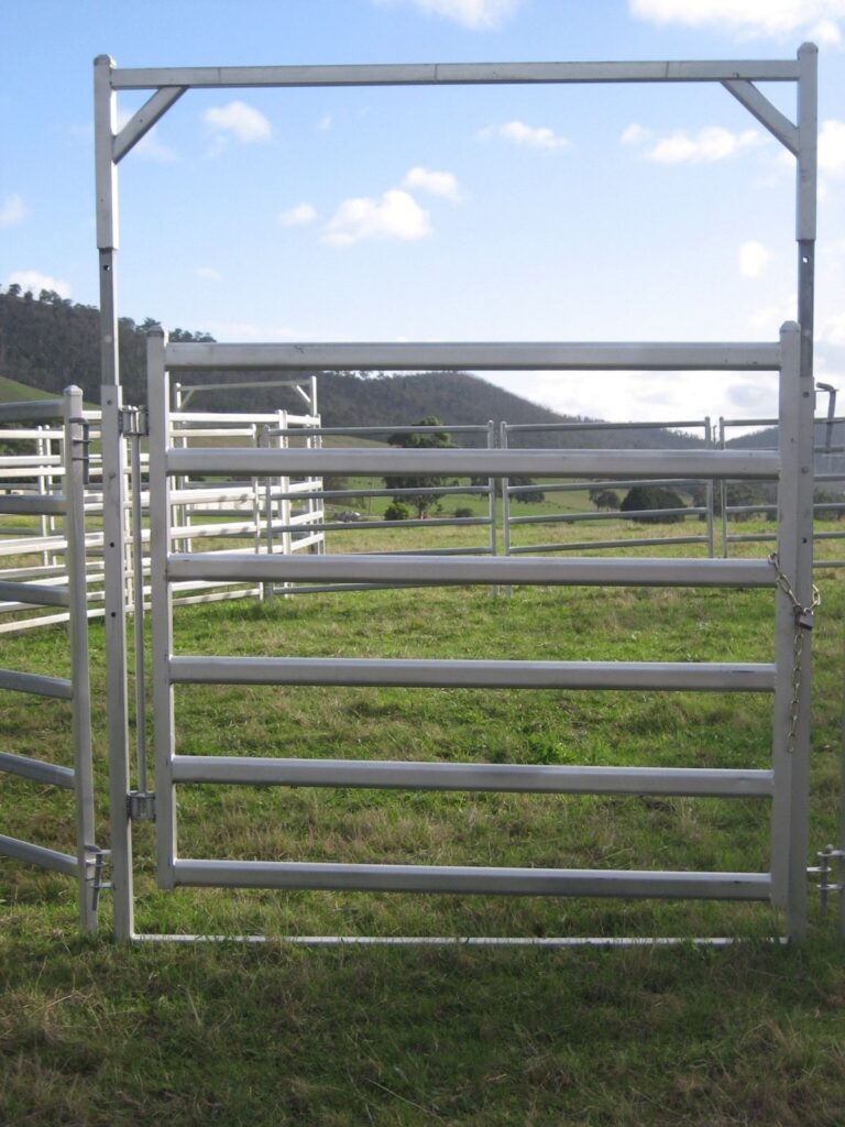 a galvanized single corral gate with cattle panels