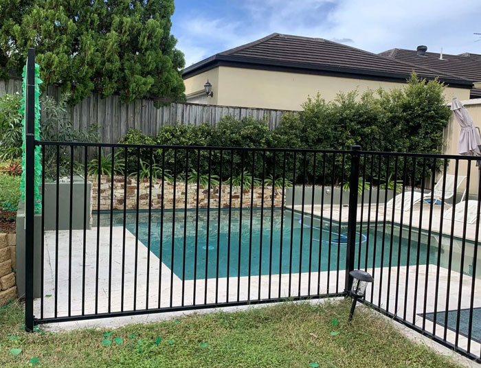 Black aluminium flat top pool fencing installation showcasing modern design and safety features