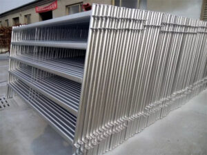 Stacked galvanized steel horse panels ready for transportation or installation.