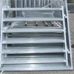 Stacked galvanized horse panels prepared for shipment, showcasing their sturdy construction and corrosion resistance.