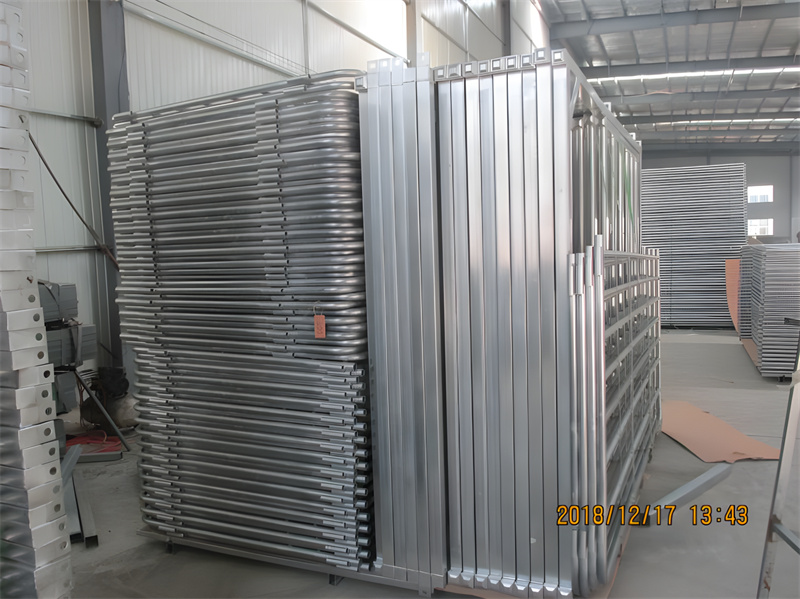 Stacked galvanized sheep panels in a warehouse, ready for distribution.