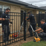 Skilled professionals installing a seamless steel fence, highlighting the importance of expertise in the installation process.