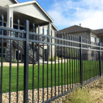 Example of a galvanized steel picket fence installation around a residential property, highlighting aesthetic appeal and security.