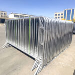 A stack of galvanized steel crowd barriers ready for transport, showcasing their sturdy design and preparation for events.