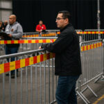 Crowd control barriers set up at an event, providing a designated area for attendees and helping maintain order during the proceedings.