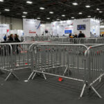 Multiple steel crowd barriers arranged within an indoor event space, effectively managing crowd flow and creating organized pathways for attendees.