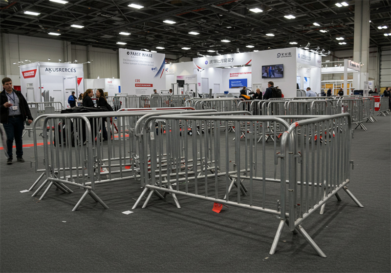 Multiple steel crowd barriers arranged within an indoor event space, effectively managing crowd flow and creating organized pathways for attendees.